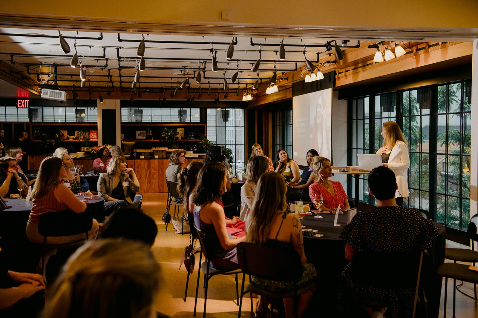 A group of women listening to a presentation at a Poker Power event