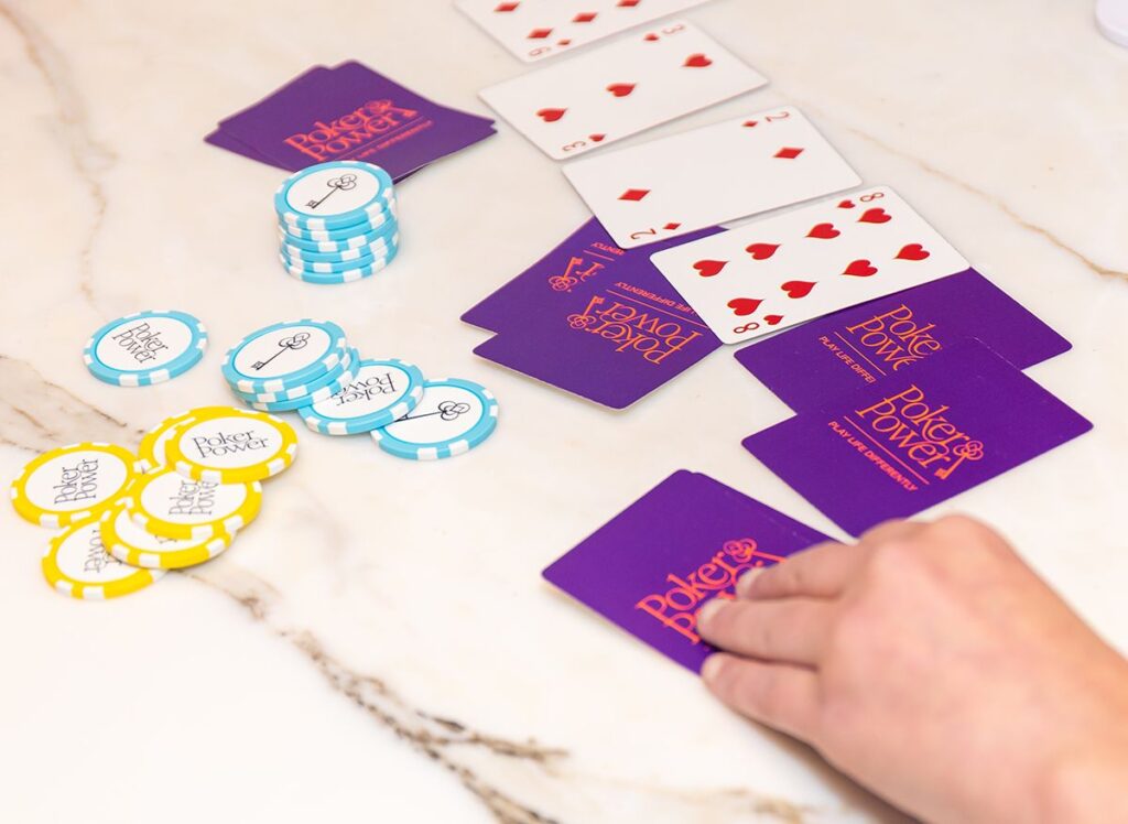 Women playing poker with Poker Power chips and cards